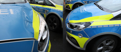 Polizeifahrzeug mit Schaden an Motorhaube und Scheinwerfer